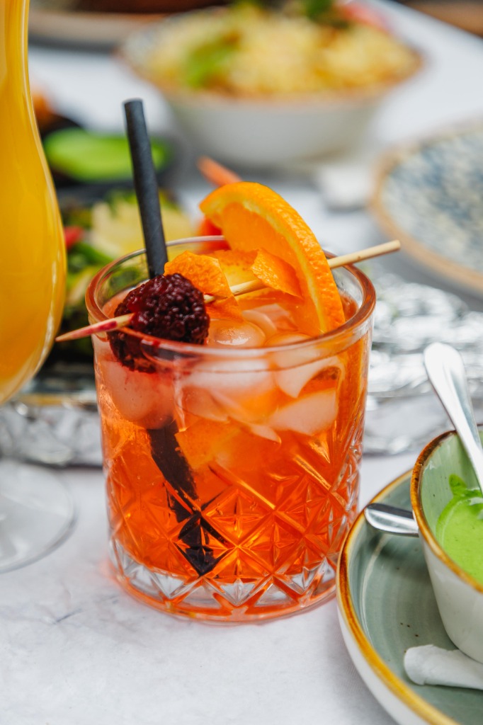 Signature cocktail with food spread